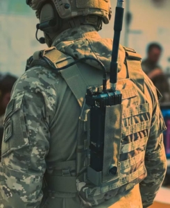 GENSS Soldier System radio mounted on the rear of a soldier’s plate carrier, illustrating lightweight, rugged beyond-line-of-sight tactical communications capability.
