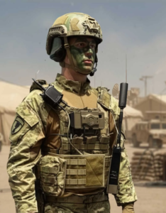 A camouflage-clad soldier stands in a desert forward operating base, equipped with the GENSS Soldier radio mounted centrally on his body armour, with a shoulder-worn control unit and a vertical tactical antenna attached to his vest. Military vehicles and tents are visible in the background.