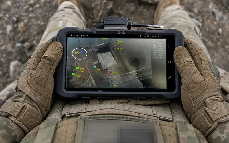ATAK Display with Hands ATAK-enabled tactical display demonstrating integrated voice and data connectivity across distributed forces