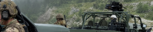 Soldiers operating with GENSS soldier-mounted and platform-mounted communications systems alongside military vehicles during a field exercise, demonstrating secure voice and data connectivity across dismounted and mobile platforms.